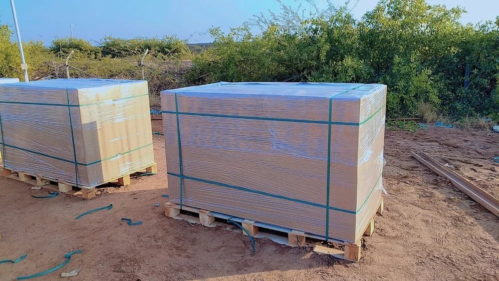 Solar modules wrapped and strapped on customised wooden solar pallets at a solar project site
